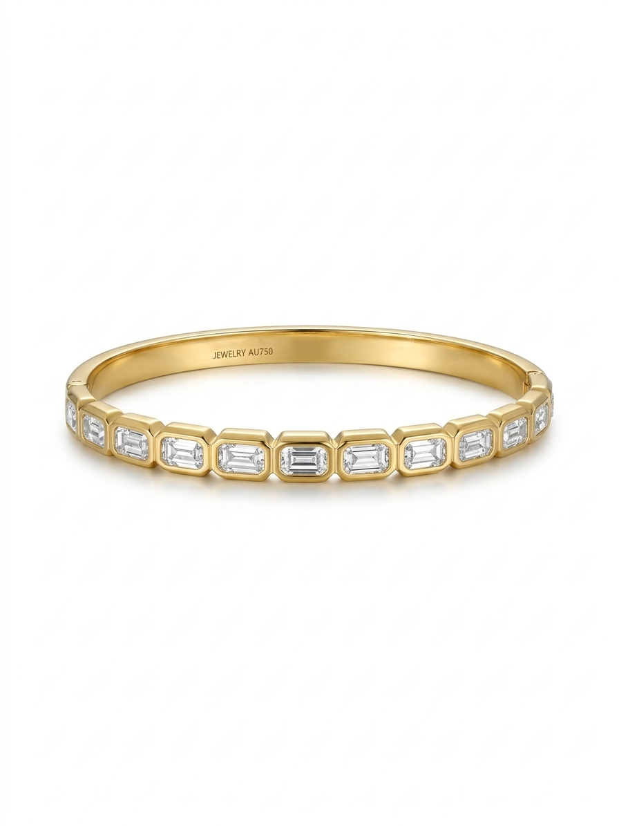 Anti-tarnish 18K gold-plated emerald-cut bezel bangle.