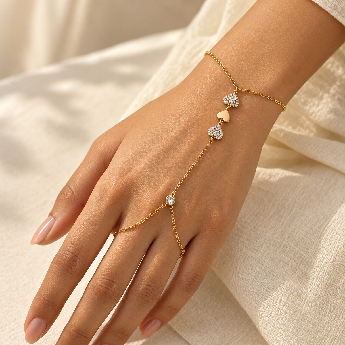 Aurelia gold-tone haathphool hand chain with delicate linked chains, round pavé stone motifs and bezel-set accents styled on a woman's hand by INDAAH.