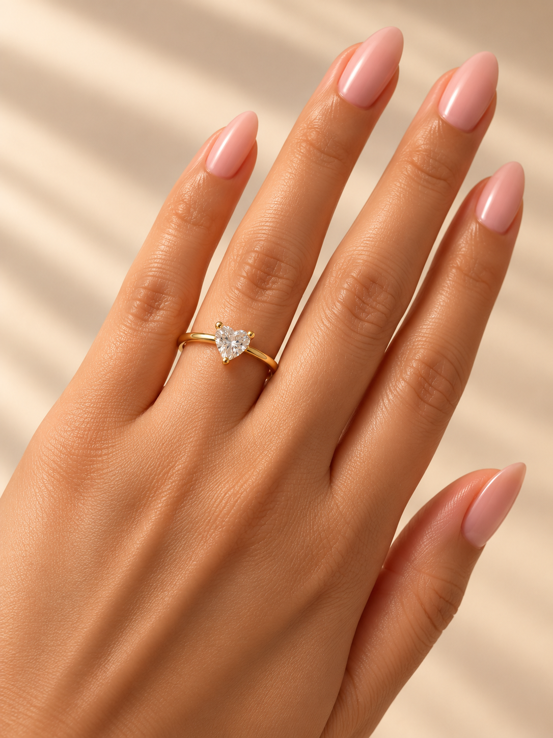 Celeste Heart Ring by INDAAH featuring a clear heart-shaped stone in a delicate gold-tone band with a three-prong setting.