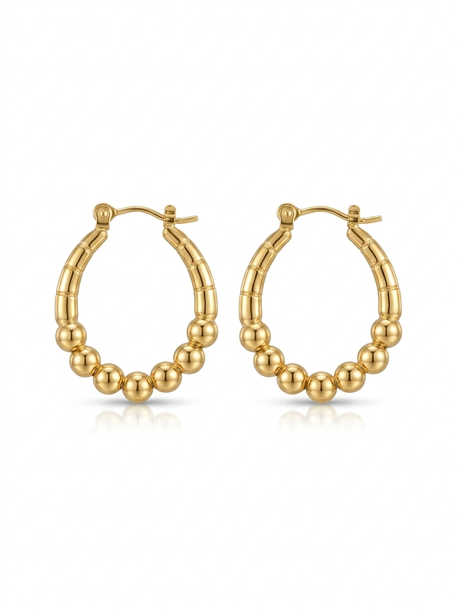 Pair of high-polish gold oval hoop earrings featuring a ribbed top and graduated beaded lower curve on a white background.