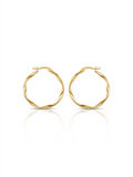 Pair of polished gold round hoop earrings featuring an organic wavy design displayed on a pure white studio background.