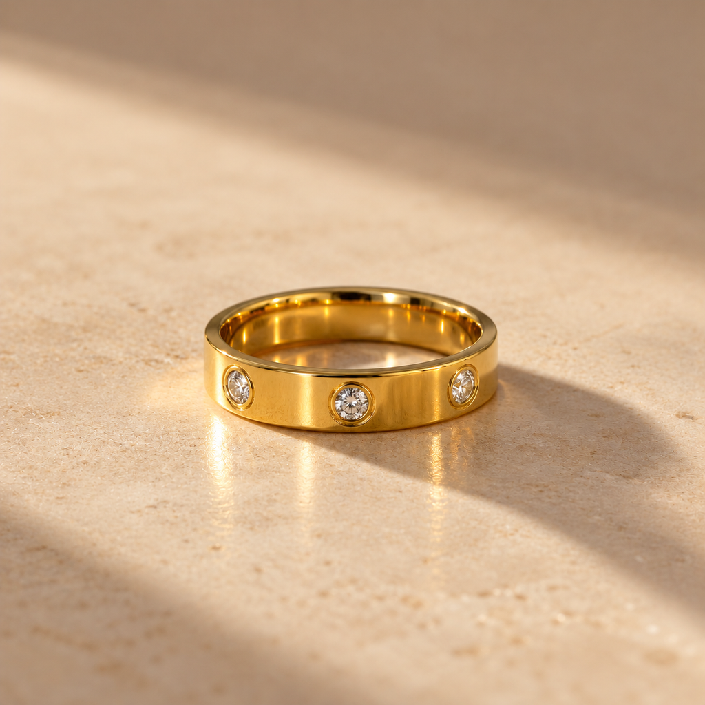 the Trinity Luxe Ring features a polished gold-tone band adorned with three sparkling round stones set in elegant bezel settings.