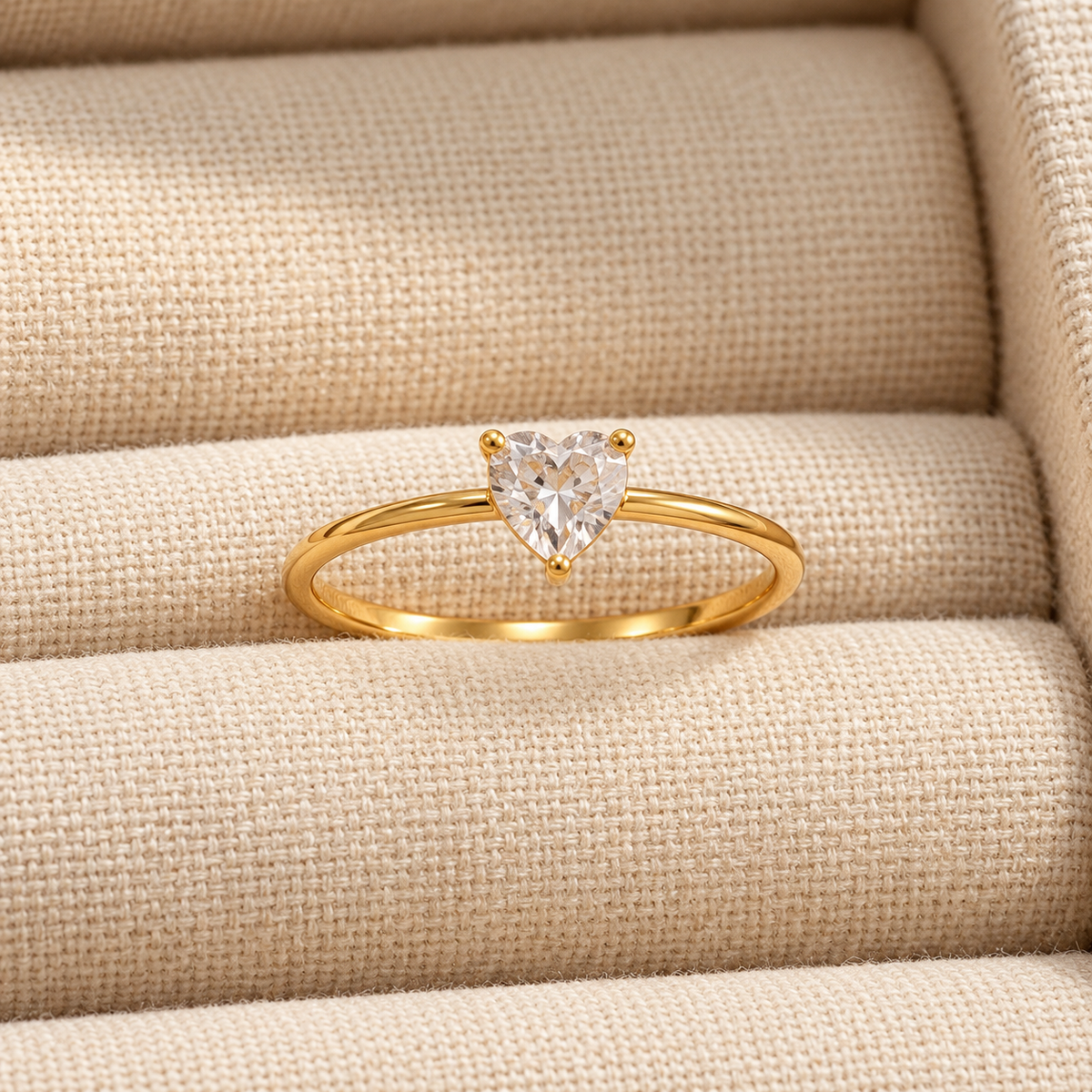 Celeste Heart Ring by INDAAH featuring a clear heart-shaped stone in a delicate gold-tone band with a three-prong setting.