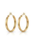 Pair of medium-sized oval hoop earrings featuring a brushed matte gold finish set against a pure white background.