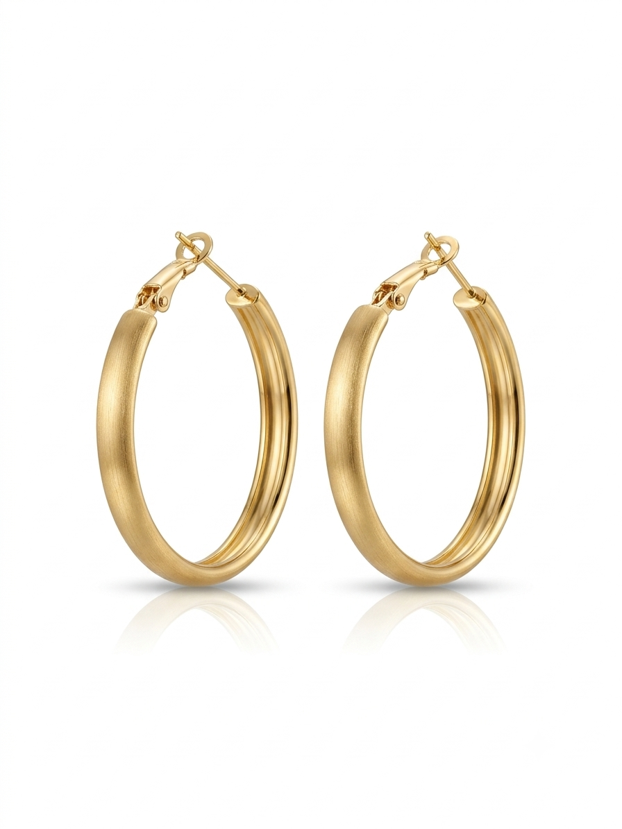 Pair of medium-sized oval hoop earrings featuring a brushed matte gold finish set against a pure white background.