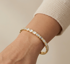 Model wearing Anti-tarnish 18K gold-plated emerald-cut bezel bangle.