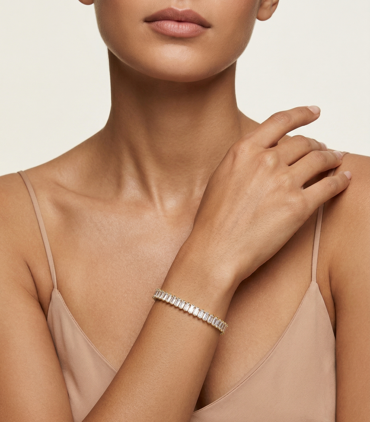 Model wearing Anti-tarnish 18K gold-plated linear tennis bracelet.