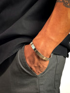 Model wearing Anti-tarnish sleek silver bangle bracelet for men.