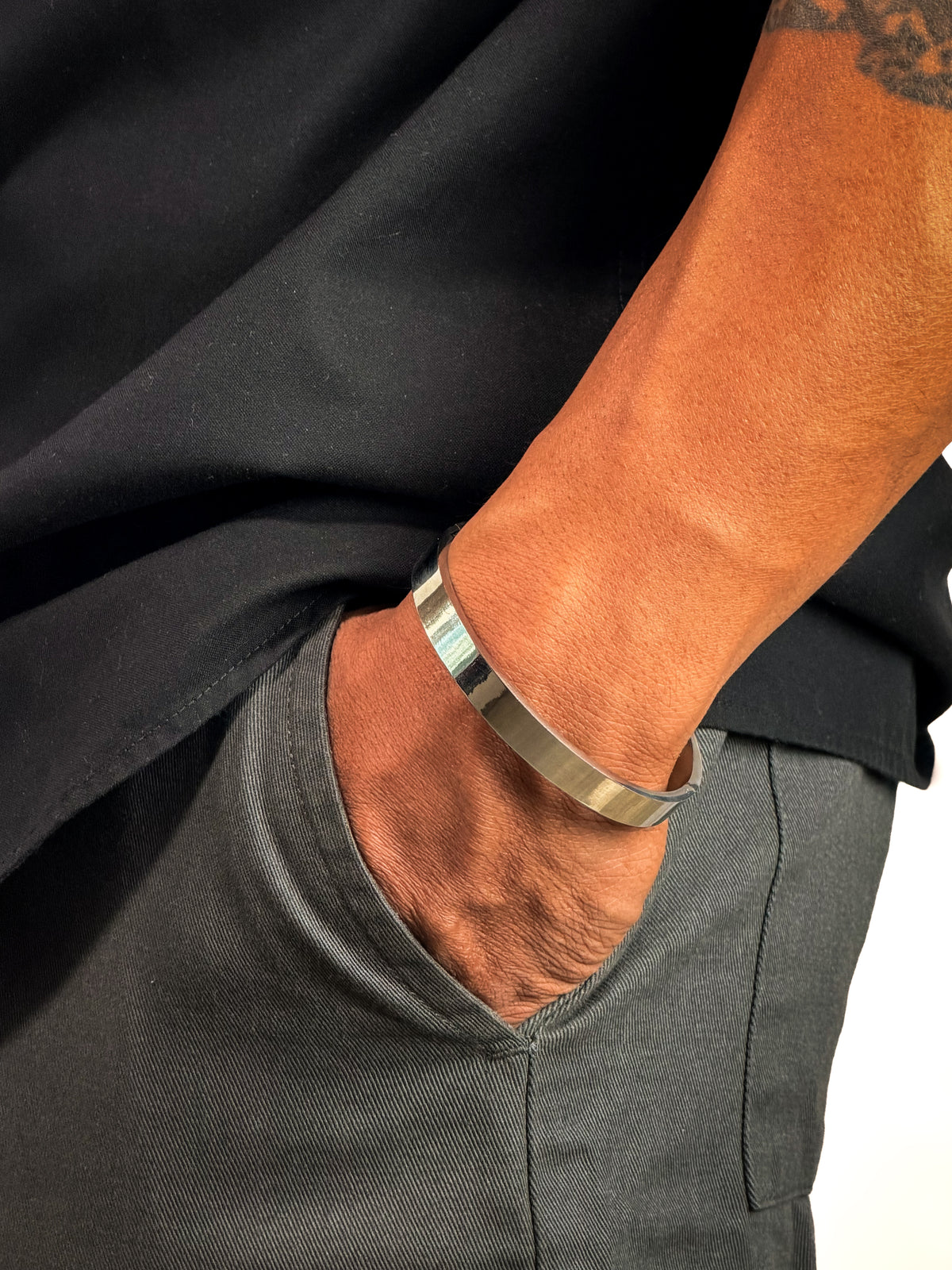 Model wearing Anti-tarnish sleek silver bangle bracelet for men.