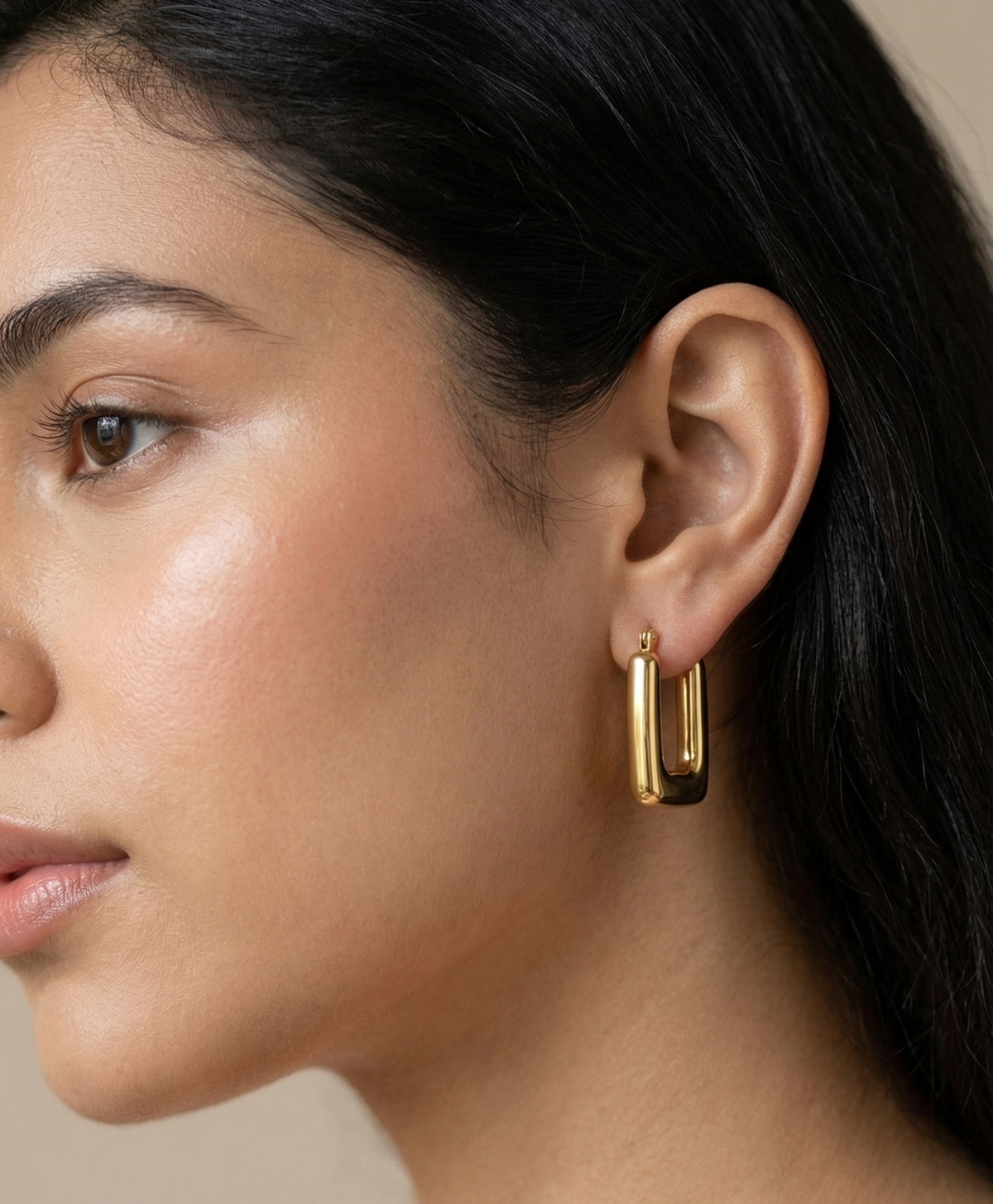 Model wearing Rectangular U-shaped gold-plated hoop earrings.