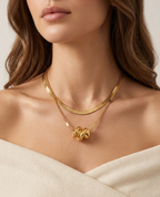 Modle wearing Anti-tarnish 18K gold-plated layered herringbone and twisted knot pendant necklace.