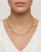 Modle wearing Anti-tarnish 18K gold-plated layered tennis and curb chain necklace.