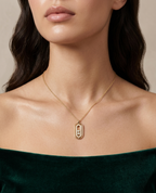 Modle wearing Anti-tarnish 18K gold-plated moving crystal oval pendant necklace.