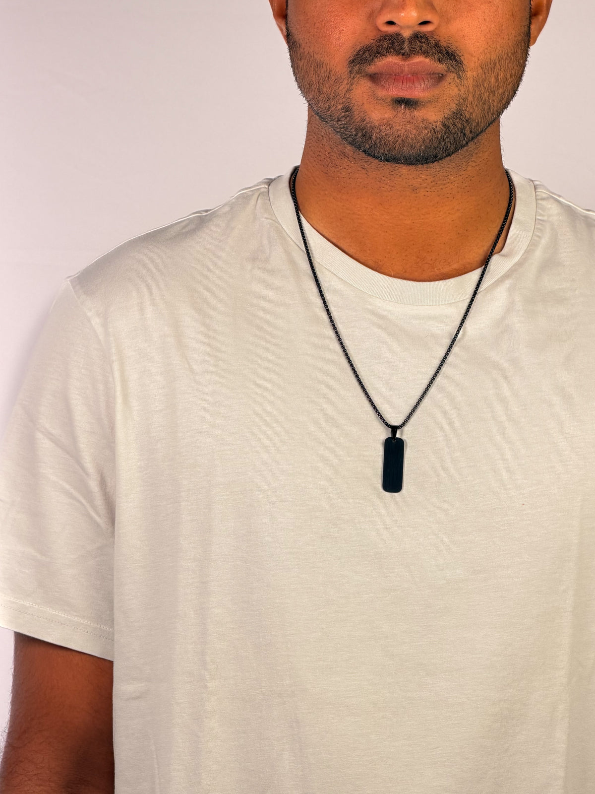 Modle wearing Anti-tarnish matte black stealth tag pendant necklace for men.