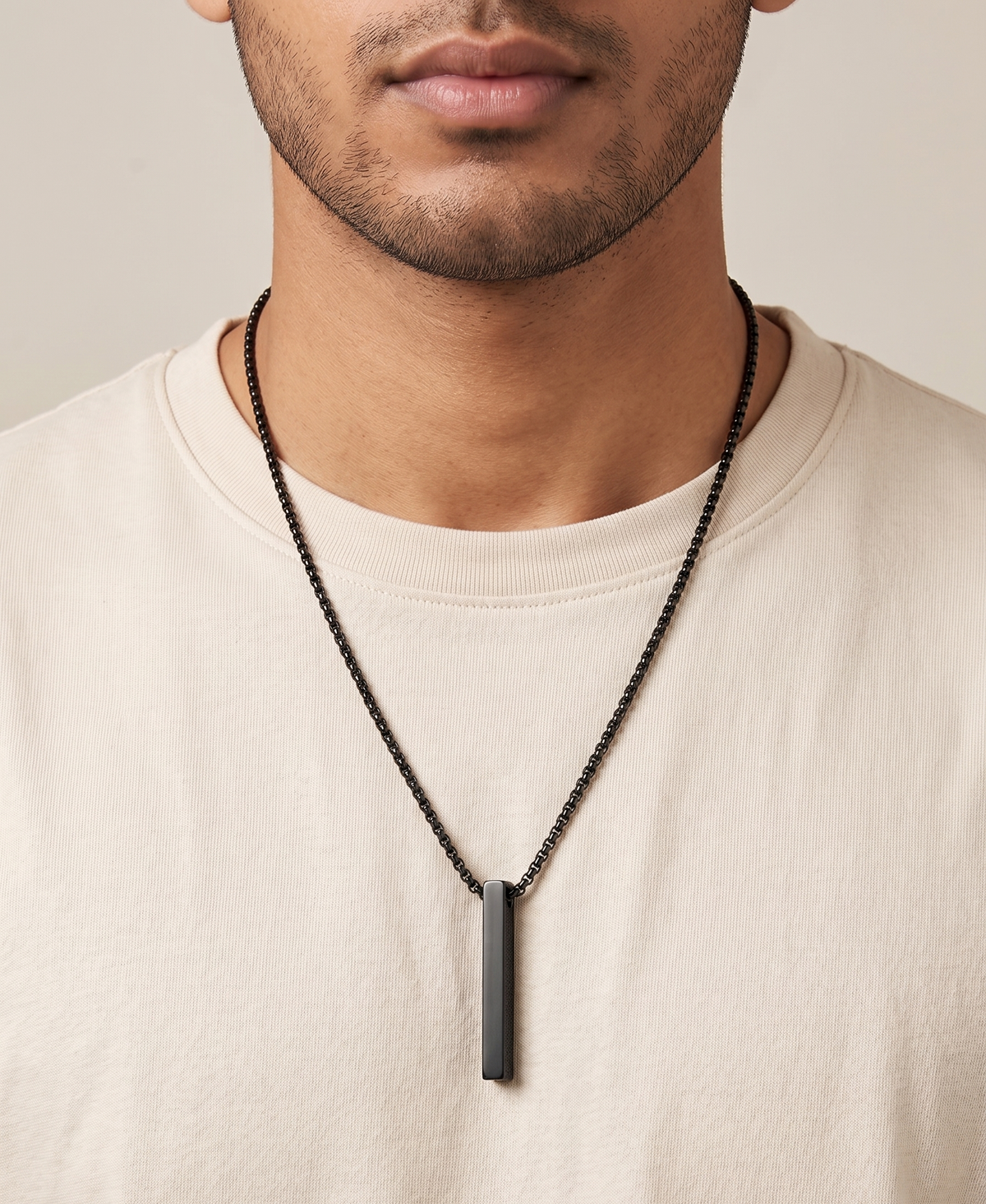 Modle wearing Anti-tarnish matte black vertical bar pendant necklace for men.