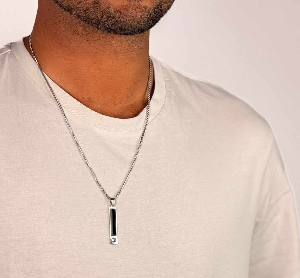 Modle wearing Anti-tarnish silver crystal-accented onyx bar pendant necklace for men.