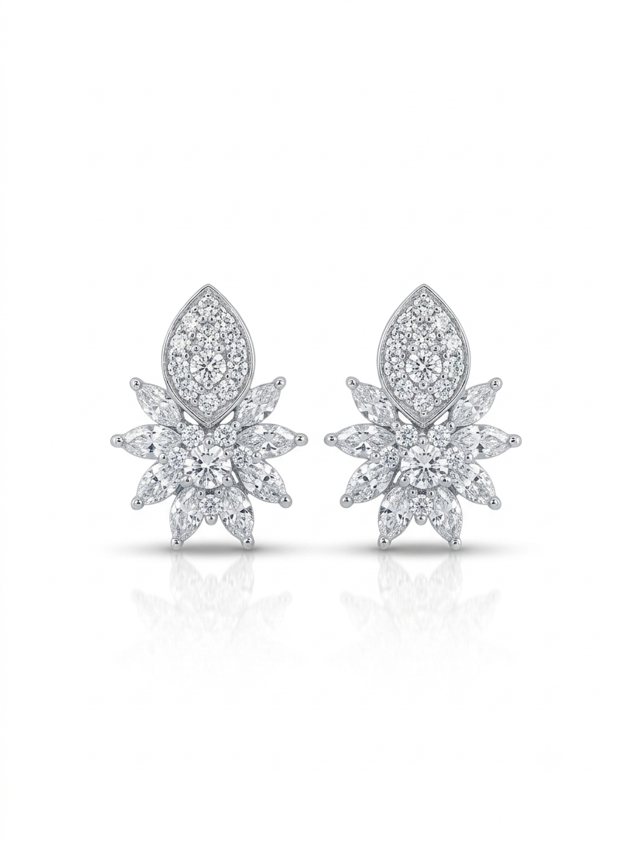 Pair of silver-tone stud earrings featuring a floral cluster of marquise stones topped with a pavé crest on a white background.