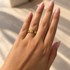 the Trinity Luxe Ring features a polished gold-tone band adorned with three sparkling round stones set in elegant bezel settings.