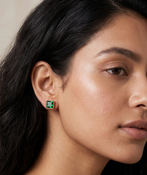 Woman wearing a gold Emerald Eden Stud earring