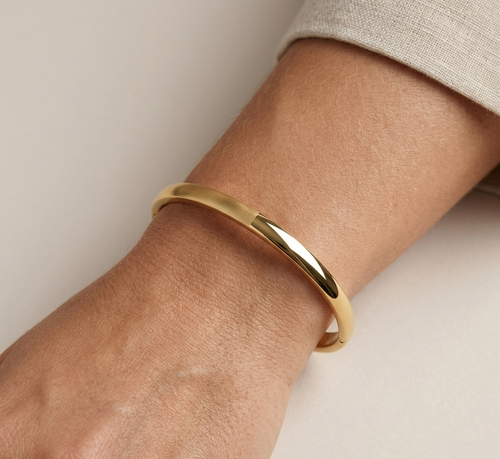Model wearing Anti-tarnish 18K gold-plated dual-finish minimalist bangle.
